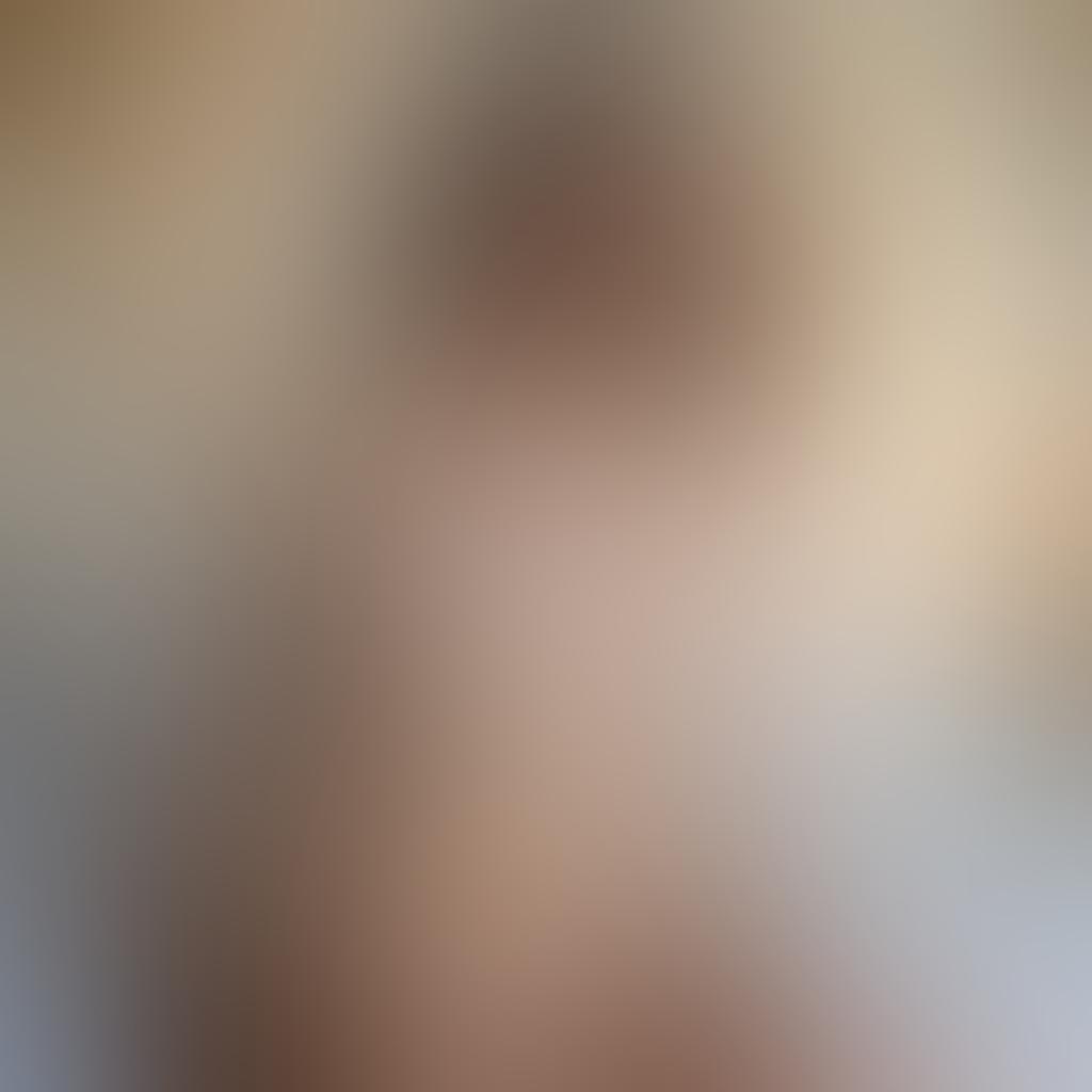 A serene and evocative nude portrait capturing the essence of vulnerability and emotion, featuring soft natural lighting illuminating the figure's delicate features. The background should be a blurred, impressionistic landscape that enhances the sense of intimacy and connection. Include subtle brush strokes and flowing textures to emphasize the fluidity of human expression. The color palette should be warm and inviting, highlighting variations in skin tones and the emotional depth of the subject. painting. warm tones. soft focus.